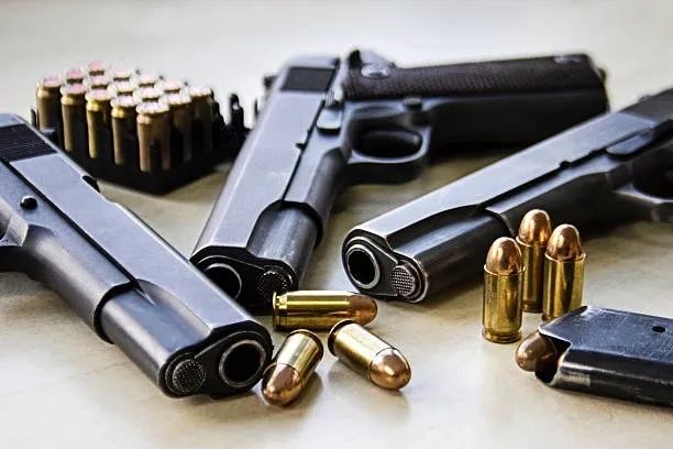 Multiple handguns and ammunition flat lay display